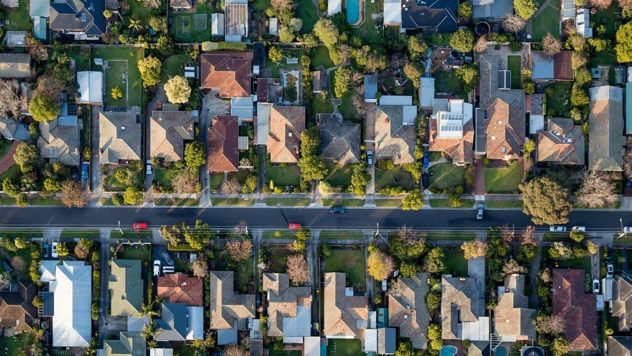 Aerial view of established detached homes along a suburban street